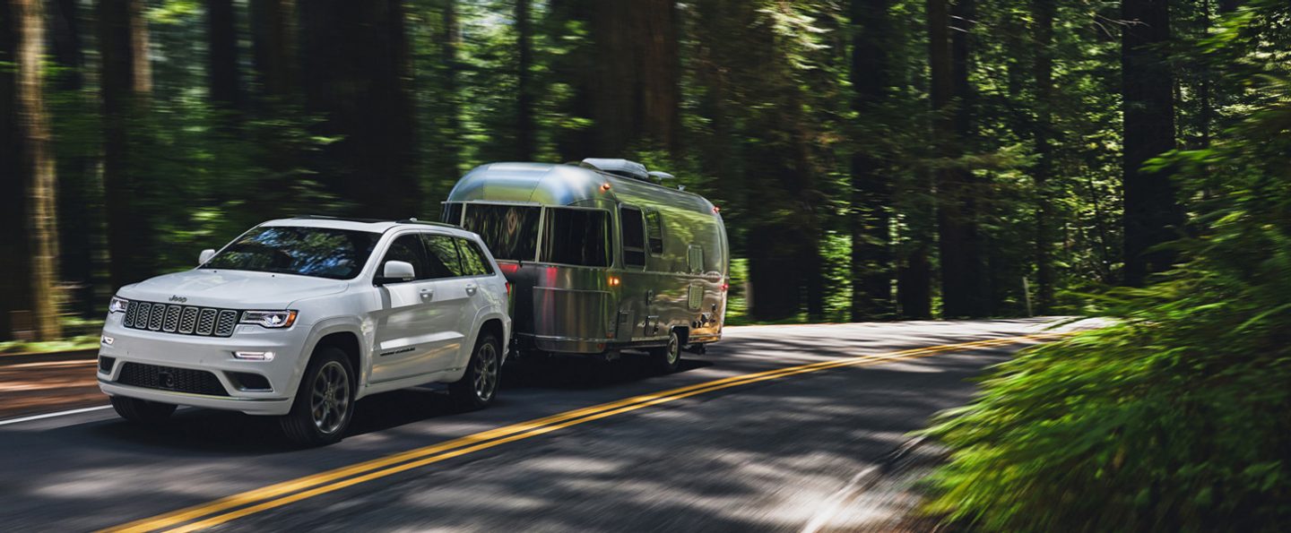 A 2020 Jeep Grand Cherokee towing a trailer.